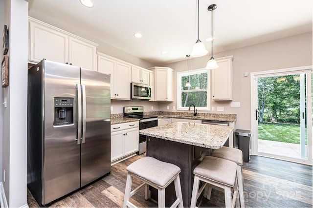 2045 13th St NE Unit 3, Hickory, NC 28601 - kitchen with stainless steel appliances, dark wood-type flooring, recessed lighting, a kitchen island, and white cabinetry