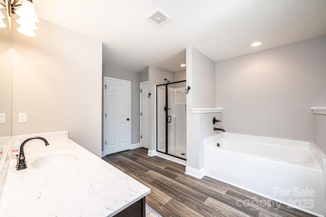 2045 13th St NE Unit 3, Hickory, NC 28601 - bathroom featuring a bath, a stall shower, double vanity, wood finished floors, and recessed lighting