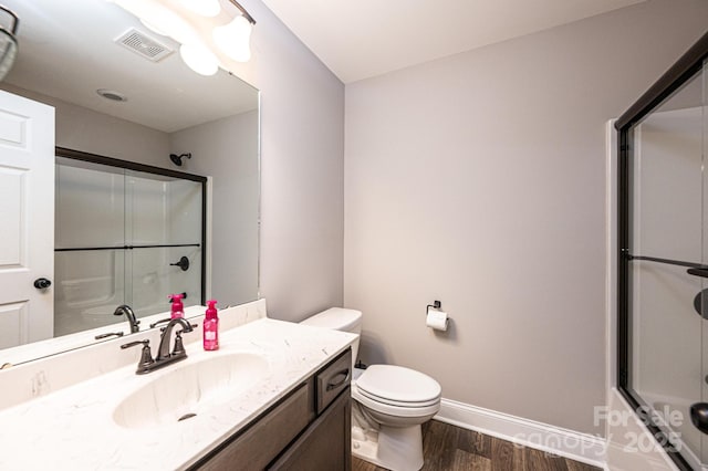 2045 13th St NE Unit 3, Hickory, NC 28601 - bathroom featuring wood finished floors, baseboards, toilet, and vanity