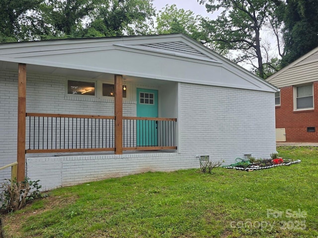 1831 Erie St, Charlotte, NC 28216 - view of property exterior featuring brick siding, a yard, and crawl space