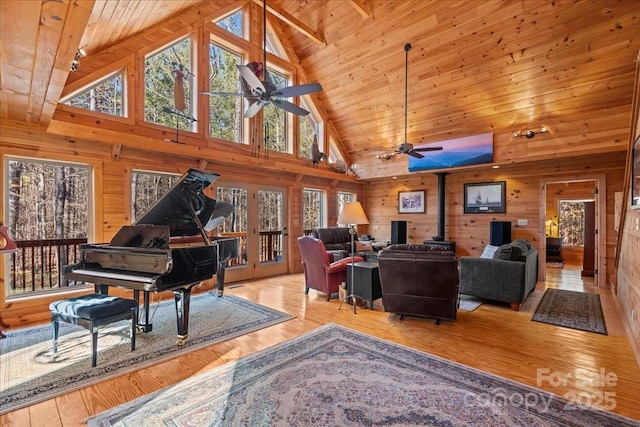 650 Mcdowell Rd, Columbus, NC 28722 - living room with a ceiling fan, a wood stove, high vaulted ceiling, wooden walls, and wood ceiling