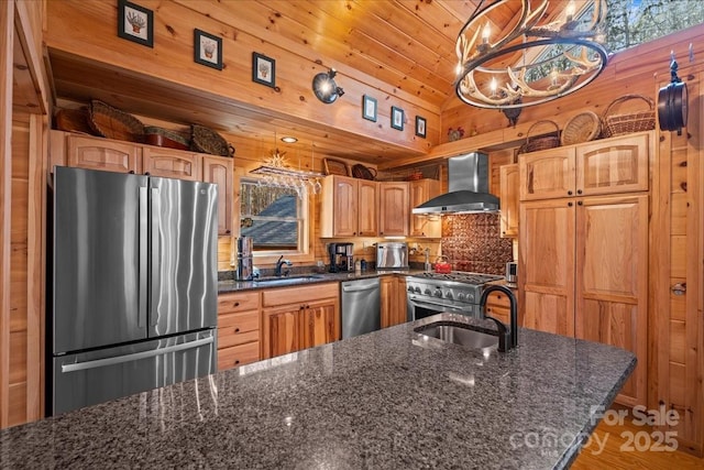 650 Mcdowell Rd, Columbus, NC 28722 - kitchen with appliances with stainless steel finishes, wall chimney range hood, a sink, backsplash, and wood walls