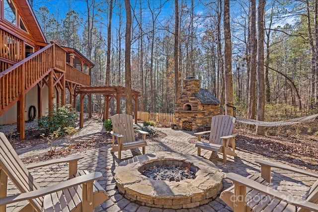 650 Mcdowell Rd, Columbus, NC 28722 - view of patio with an outdoor stone fireplace, an outdoor fire pit, a wooden deck, and stairs