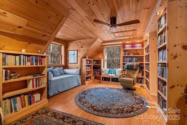 650 Mcdowell Rd, Columbus, NC 28722 - sitting room featuring wood ceiling, wood finished floors, a ceiling fan, wooden walls, and wall of books