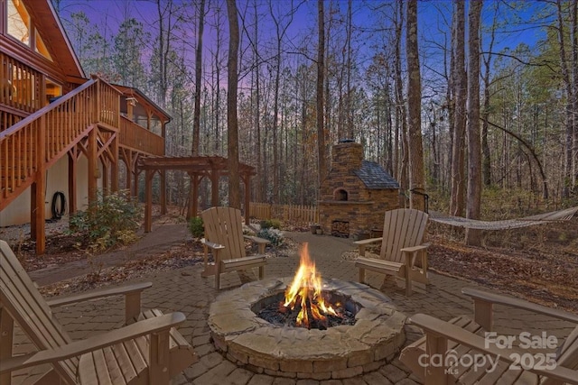 650 Mcdowell Rd, Columbus, NC 28722 - view of patio with a fire pit, an outdoor stone fireplace, stairway, and a wooden deck
