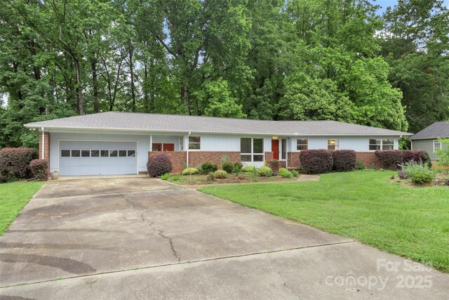2666 Providence Dr, Gastonia, NC 28052 - ranch-style home with an attached garage, concrete driveway, a front yard, brick siding, and a shingled roof