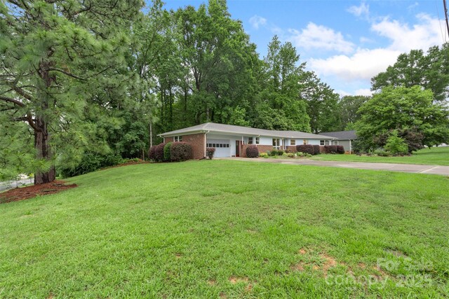 2666 Providence Dr, Gastonia, NC 28052 - ranch-style home featuring an attached garage, a front lawn, brick siding, and concrete driveway