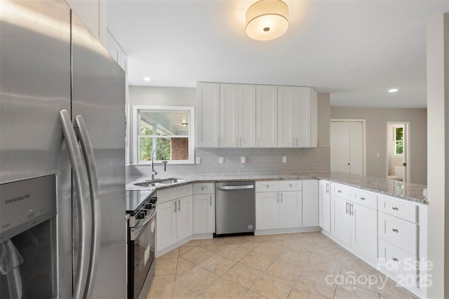 2666 Providence Dr, Gastonia, NC 28052 - kitchen featuring appliances with stainless steel finishes, a sink, decorative backsplash, healthy amount of natural light, and recessed lighting