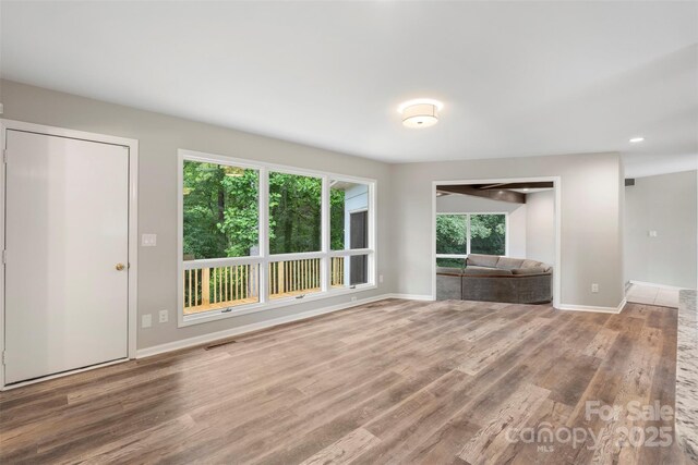2666 Providence Dr, Gastonia, NC 28052 - unfurnished living room featuring wood finished floors, baseboards, and recessed lighting