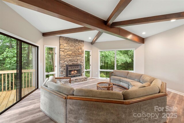 2666 Providence Dr, Gastonia, NC 28052 - living area featuring beam ceiling, plenty of natural light, a stone fireplace, light wood-style floors, and recessed lighting