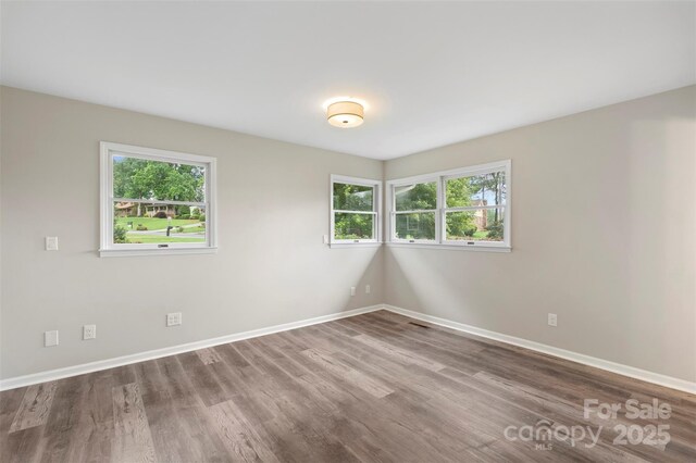 2666 Providence Dr, Gastonia, NC 28052 - unfurnished room featuring wood finished floors, healthy amount of natural light, and baseboards