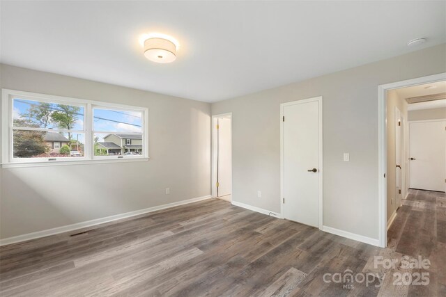 2666 Providence Dr, Gastonia, NC 28052 - unfurnished bedroom featuring wood finished floors and baseboards