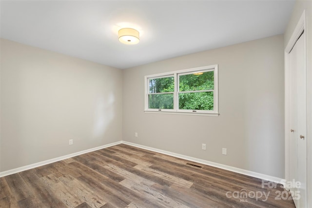 2666 Providence Dr, Gastonia, NC 28052 - unfurnished bedroom featuring wood finished floors, a closet, and baseboards