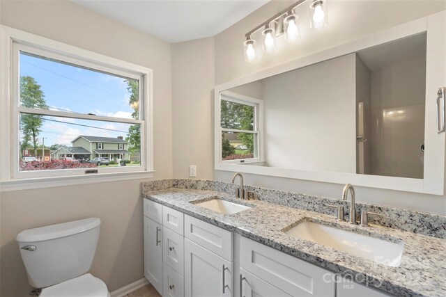 2666 Providence Dr, Gastonia, NC 28052 - bathroom featuring healthy amount of natural light, double vanity, toilet, and baseboards