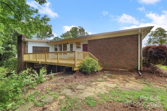 2666 Providence Dr, Gastonia, NC 28052 - rear view of house with a wooden deck, brick siding, and a chimney
