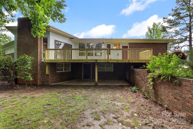 2666 Providence Dr, Gastonia, NC 28052 - rear view of house featuring a wooden deck, a chimney, and brick siding