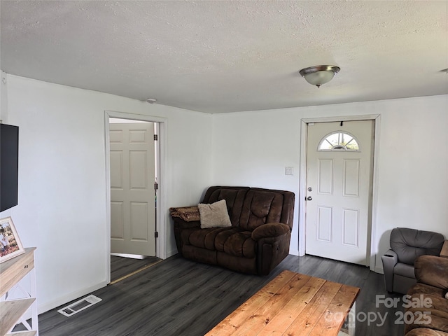 23 Pearl St, Granite Falls, NC 28630 - living area with dark wood-type flooring and a textured ceiling
