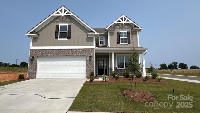 102 Cartington Way Unit Haf0042, Mooresville, NC 28115 - craftsman-style home with board and batten siding, concrete driveway, a front yard, a garage, and covered porch
