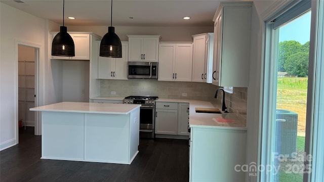 102 Cartington Way Unit Haf0042, Mooresville, NC 28115 - kitchen featuring appliances with stainless steel finishes, dark wood-style flooring, tasteful backsplash, light countertops, and recessed lighting