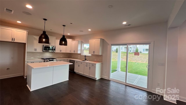 102 Cartington Way Unit Haf0042, Mooresville, NC 28115 - kitchen featuring stainless steel microwave, dishwasher, tasteful backsplash, dark wood finished floors, and white cabinetry