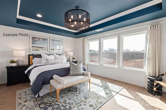 102 Cartington Way Unit Haf0042, Mooresville, NC 28115 - bedroom featuring a raised ceiling, a chandelier, crown molding, wood finished floors, and recessed lighting
