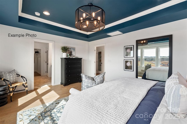 102 Cartington Way Unit Haf0042, Mooresville, NC 28115 - bedroom featuring a chandelier, a raised ceiling, light wood-style floors, recessed lighting, and crown molding