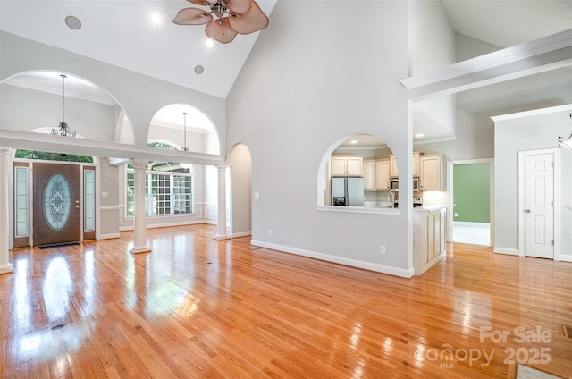 3917 Erskine Woods Dr, Bessemer City, NC 28016 - entryway with a ceiling fan, high vaulted ceiling, decorative columns, light wood-style flooring, and baseboards