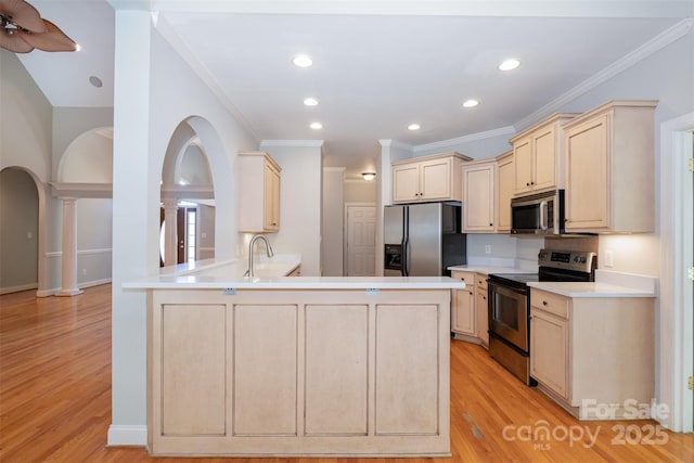 3917 Erskine Woods Dr, Bessemer City, NC 28016 - kitchen with stainless steel appliances, light brown cabinets, light wood-type flooring, a peninsula, and ornamental molding
