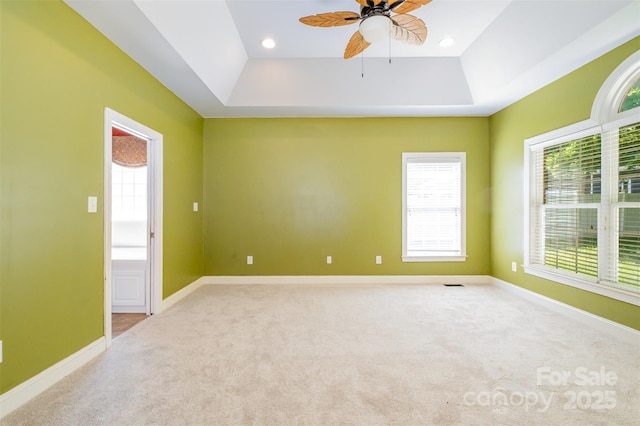 3917 Erskine Woods Dr, Bessemer City, NC 28016 - spare room featuring a raised ceiling, ceiling fan, healthy amount of natural light, and carpet flooring