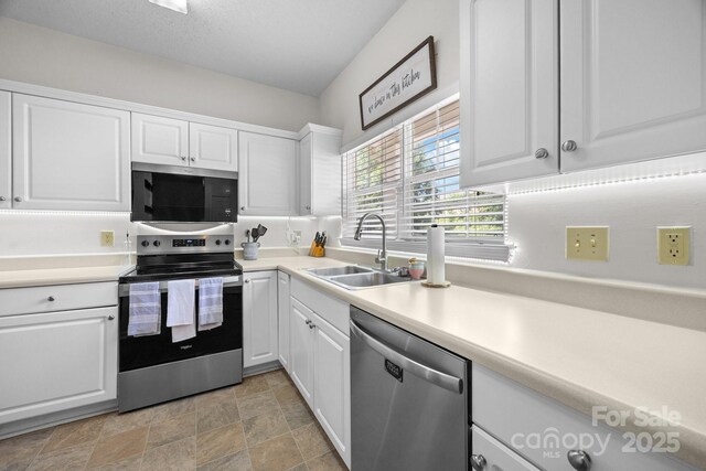740 Tavern Ct Unit 7, Rock Hill, SC 29732 - kitchen with appliances with stainless steel finishes, a sink, white cabinetry, light countertops, and stone finish floors