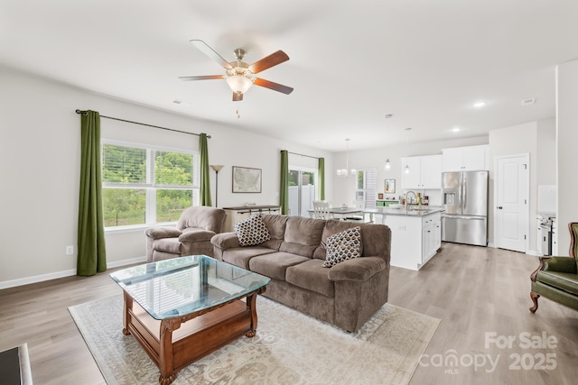 5204 Belstone Ln, Charlotte, NC 28215 - living room featuring ceiling fan, light wood-style floors, baseboards, and recessed lighting