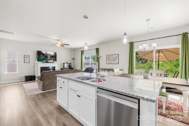 5204 Belstone Ln, Charlotte, NC 28215 - kitchen with stainless steel dishwasher, a ceiling fan, a sink, light wood-style floors, and a kitchen island with sink