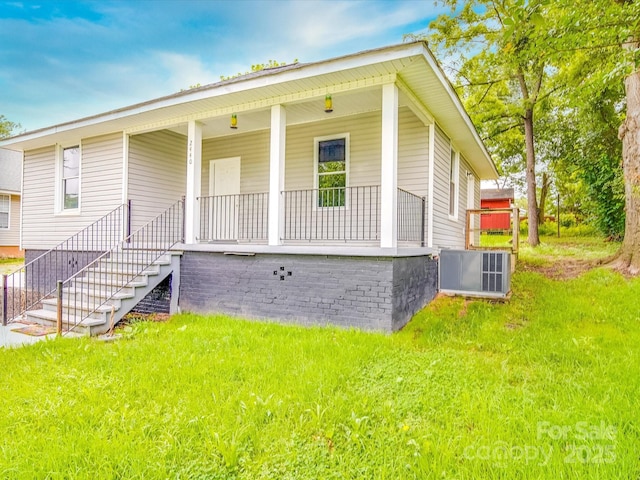 2440 Myers St, Gastonia, NC 28056 - view of front of house with a porch, cooling unit, stairs, and a front lawn