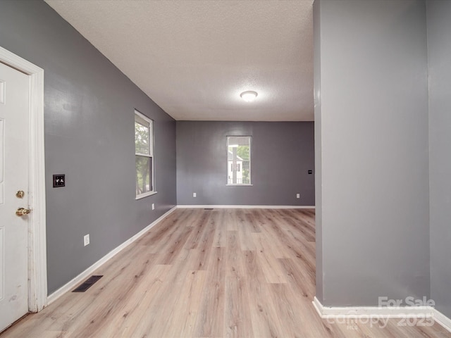 2440 Myers St, Gastonia, NC 28056 - empty room featuring a textured ceiling, light wood-style floors, and baseboards