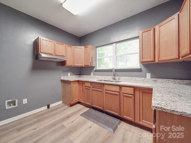 2440 Myers St, Gastonia, NC 28056 - kitchen featuring under cabinet range hood, a sink, light wood finished floors, light stone countertops, and a textured ceiling