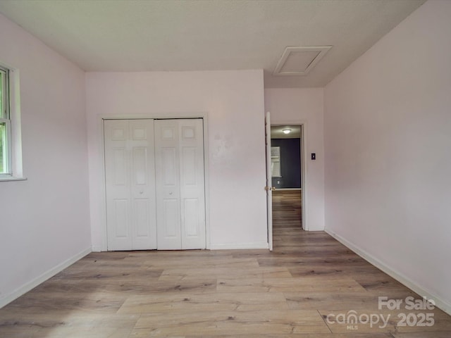 2440 Myers St, Gastonia, NC 28056 - unfurnished bedroom with attic access, light wood-type flooring, baseboards, and a closet