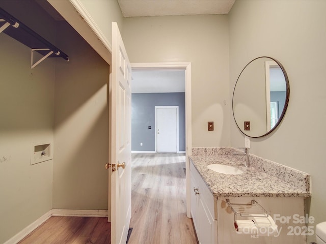 2440 Myers St, Gastonia, NC 28056 - half bath with wood finished floors, vanity, toilet, and baseboards