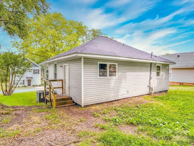2440 Myers St, Gastonia, NC 28056 - rear view of house with central air condition unit, a yard, and a shingled roof