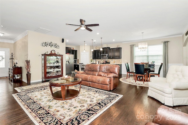 12014 Belmont Mansion Dr, Charlotte, NC 28273 - living area with ceiling fan, crown molding, healthy amount of natural light, dark wood finished floors, and a chandelier