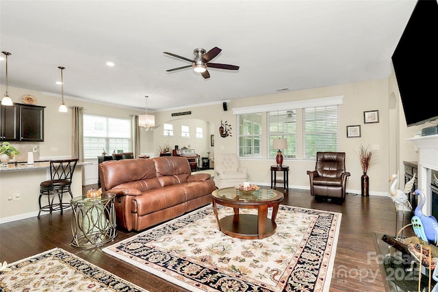 12014 Belmont Mansion Dr, Charlotte, NC 28273 - living area with ceiling fan, dark wood finished floors, a fireplace, and arched walkways
