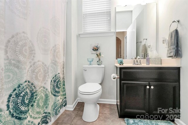 12014 Belmont Mansion Dr, Charlotte, NC 28273 - full bathroom featuring vanity, toilet, tile patterned flooring, baseboards, and a shower with curtain