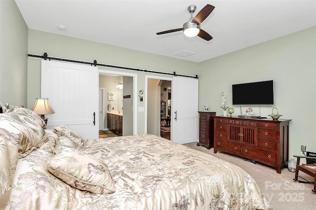 12014 Belmont Mansion Dr, Charlotte, NC 28273 - carpeted bedroom featuring a barn door, ceiling fan, and connected bathroom