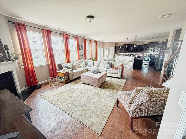 3416 Yarmouth Ln, Gastonia, NC 28056 - living area featuring dark wood-style floors, plenty of natural light, and a fireplace