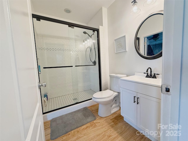 3416 Yarmouth Ln, Gastonia, NC 28056 - bathroom with wood finished floors, a stall shower, vanity, and toilet
