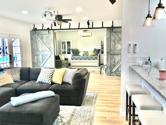 3416 Yarmouth Ln, Gastonia, NC 28056 - living area featuring a barn door, a wall unit AC, light wood-style floors, a ceiling fan, and recessed lighting