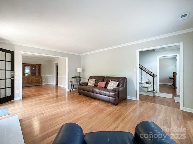 2619 Quailrush Rd, Charlotte, NC 28226 - living area with light wood finished floors, stairs, crown molding, and baseboards
