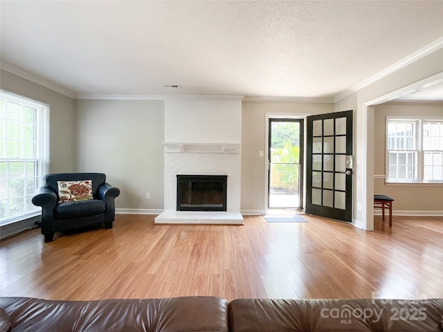 2619 Quailrush Rd, Charlotte, NC 28226 - living area with wood finished floors, ornamental molding, a brick fireplace, baseboards, and a textured ceiling