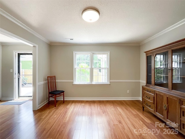 2619 Quailrush Rd, Charlotte, NC 28226 - spare room with light wood-style floors, a textured ceiling, baseboards, and ornamental molding