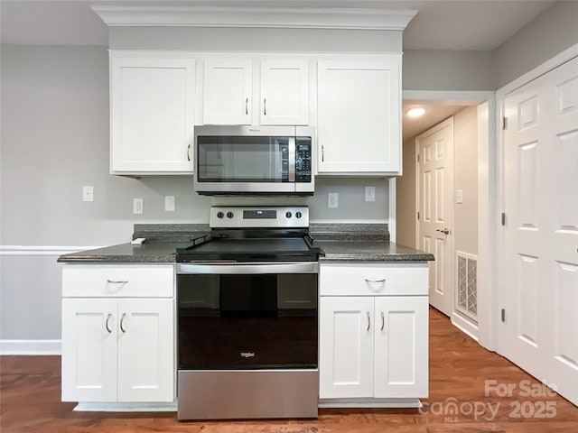2619 Quailrush Rd, Charlotte, NC 28226 - kitchen with appliances with stainless steel finishes, dark countertops, and white cabinetry