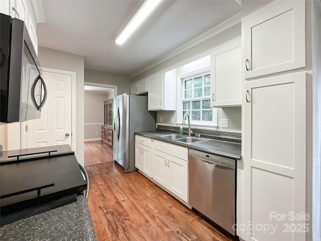 2619 Quailrush Rd, Charlotte, NC 28226 - kitchen with stainless steel appliances, a sink, dark countertops, and white cabinets
